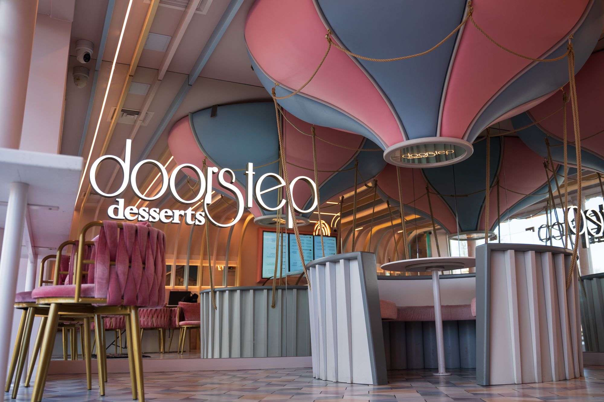 Doorstep Desserts parlour with pink balloon ceiling and illuminated logo