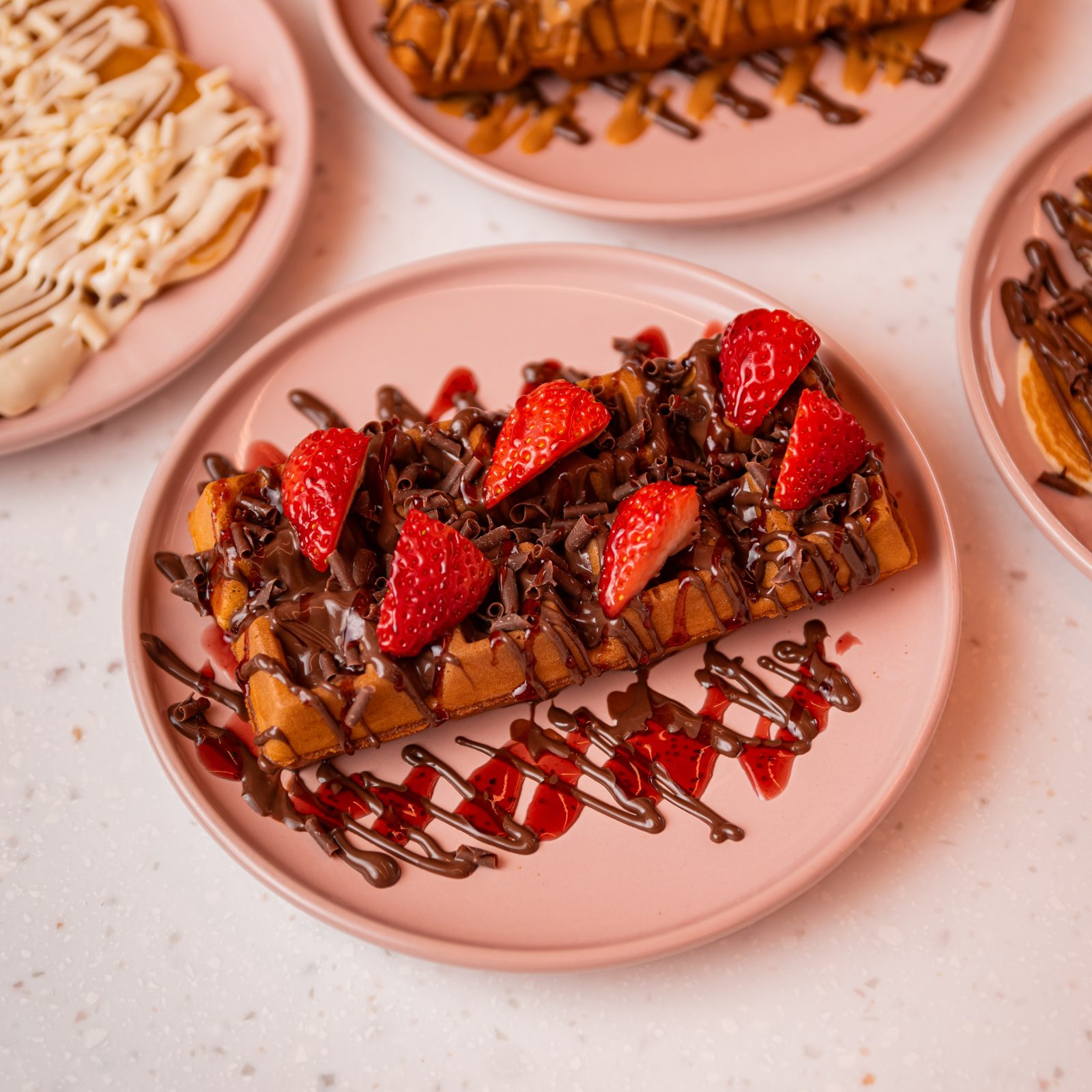 Table spread of Doorstep Desserts waffles, cookie dough and sweet treats