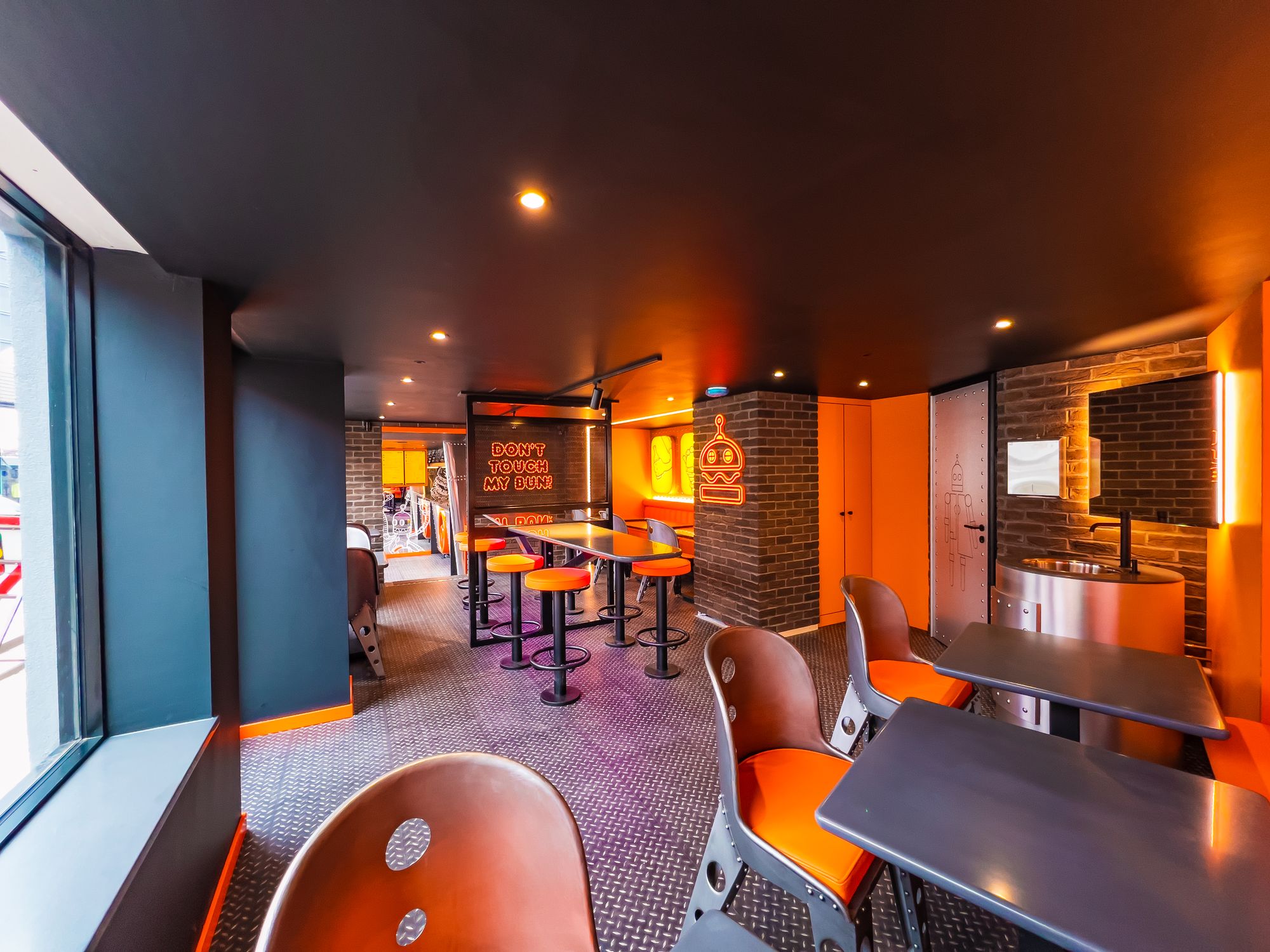 PHAT Buns dining room with orange seating
